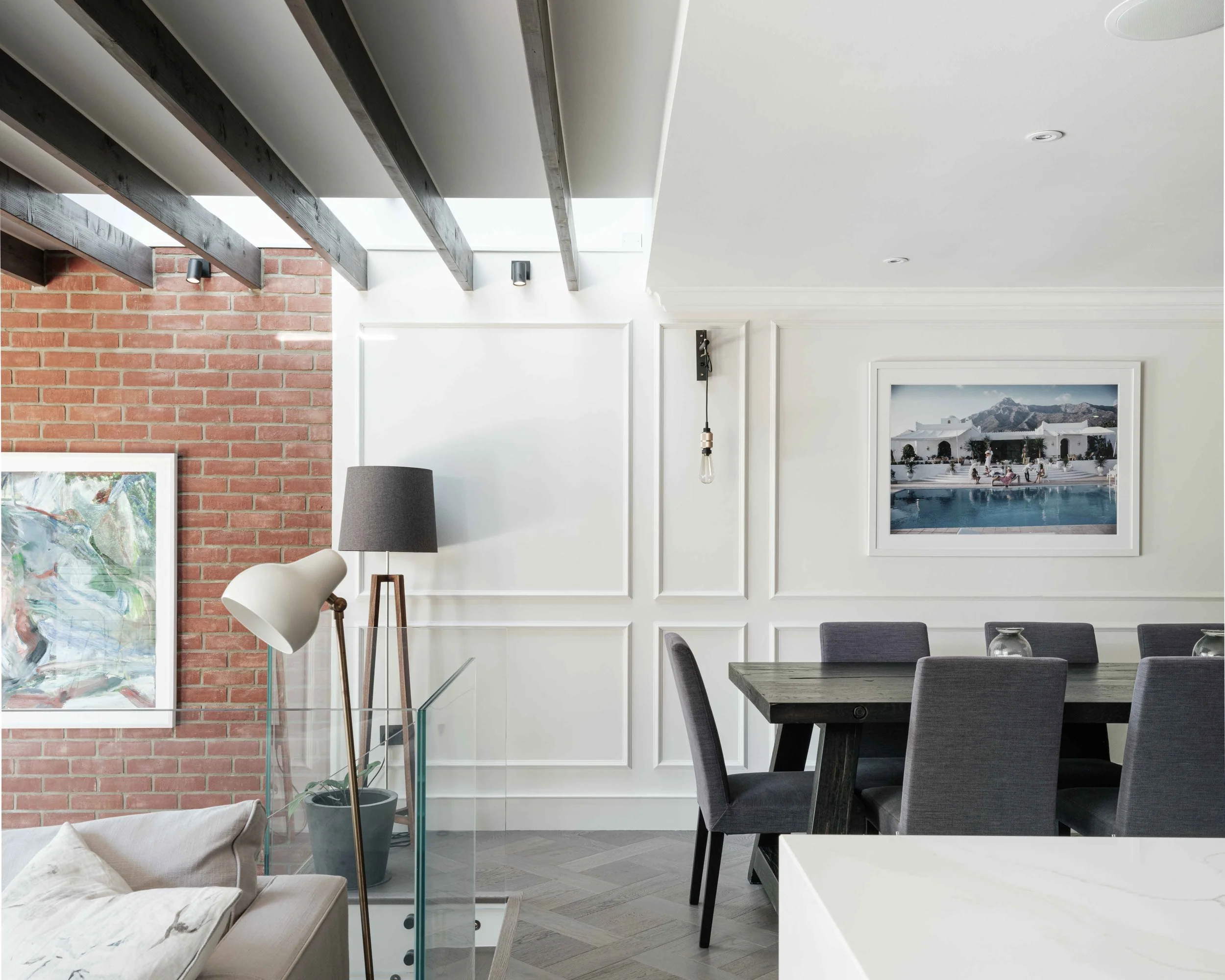 Split level dining area with exposed rafters