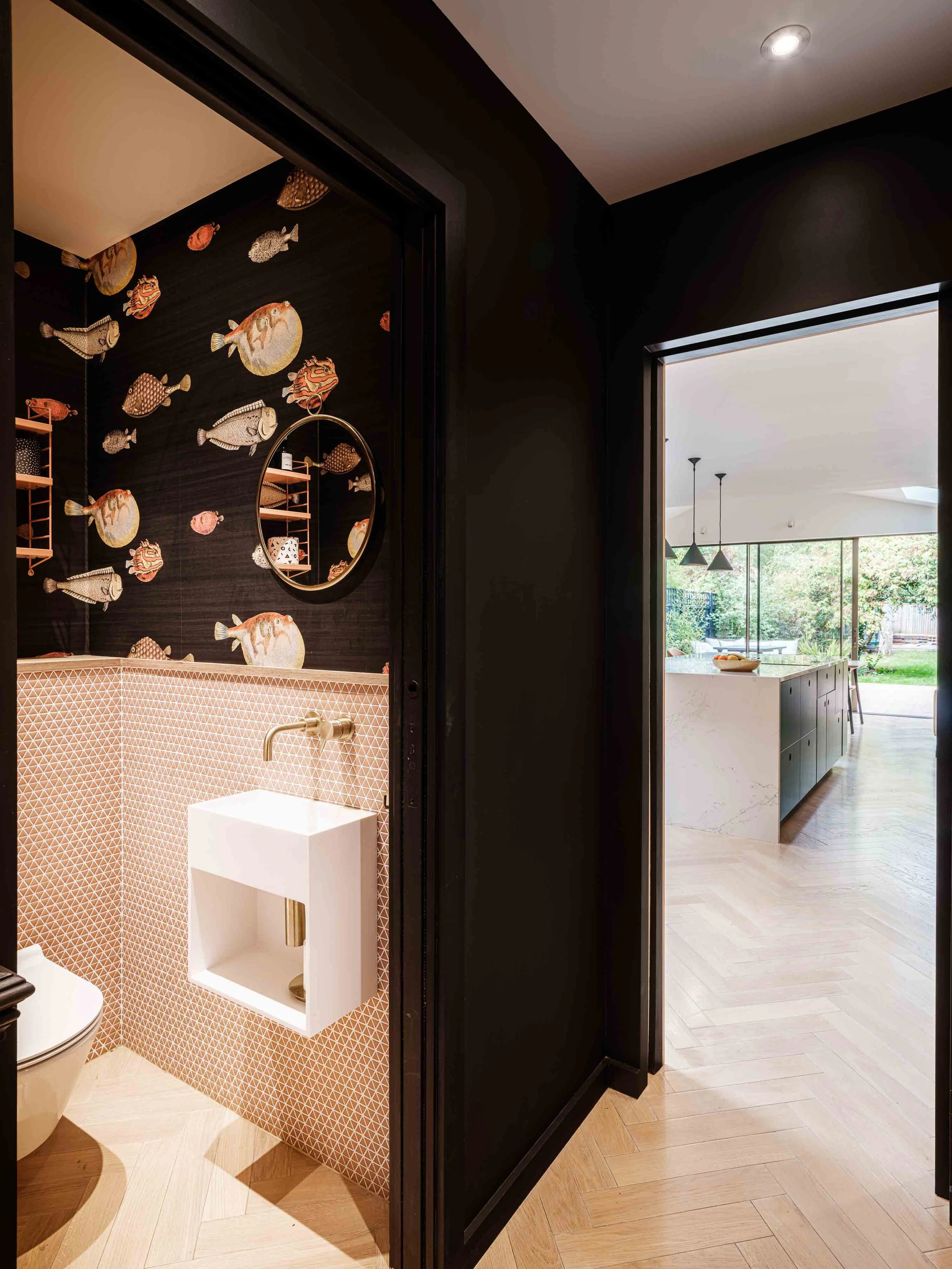 Pink tiled WC with fish wallpaper