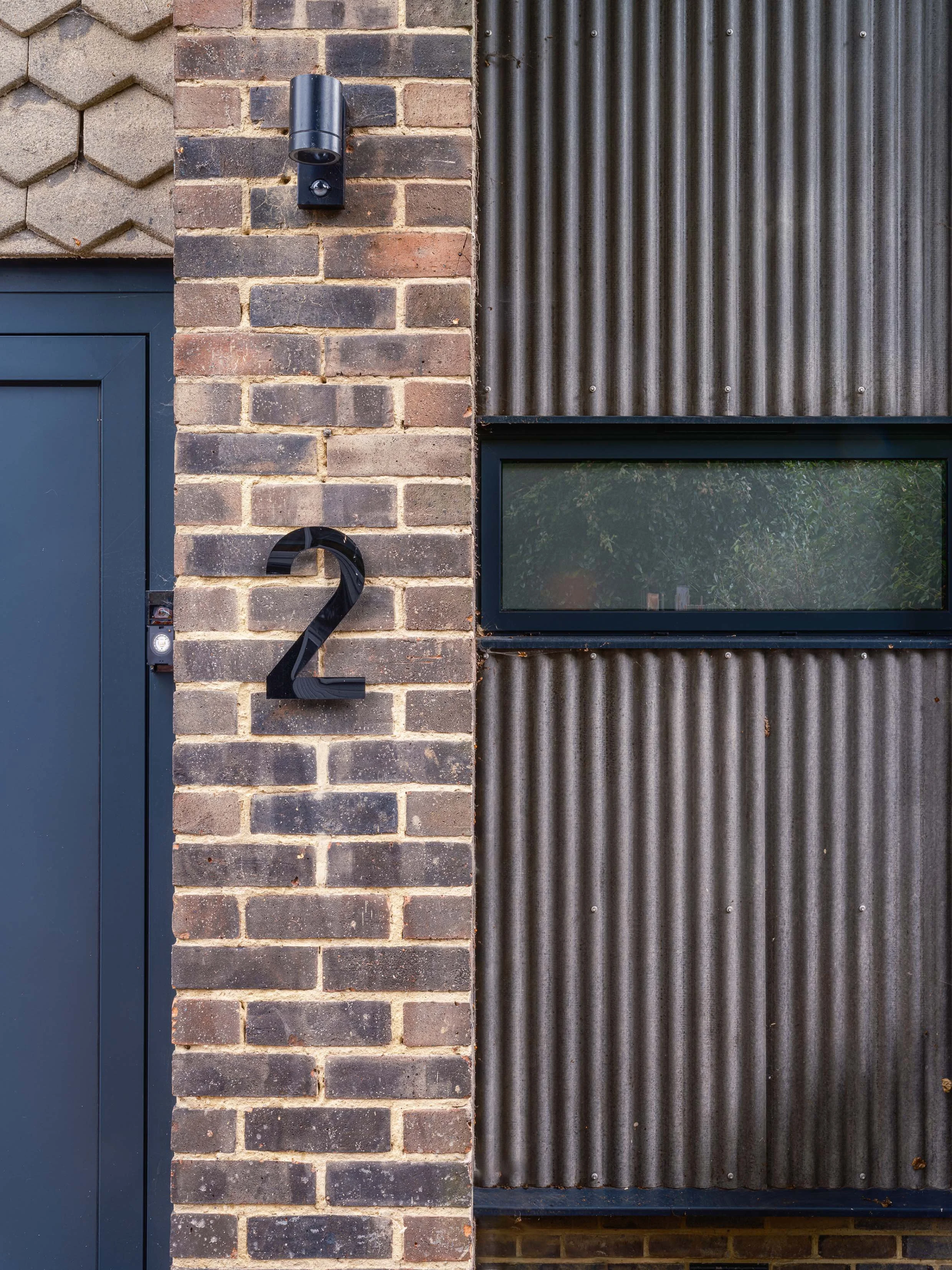 Corrugated cladding against existing tiles and brickwork