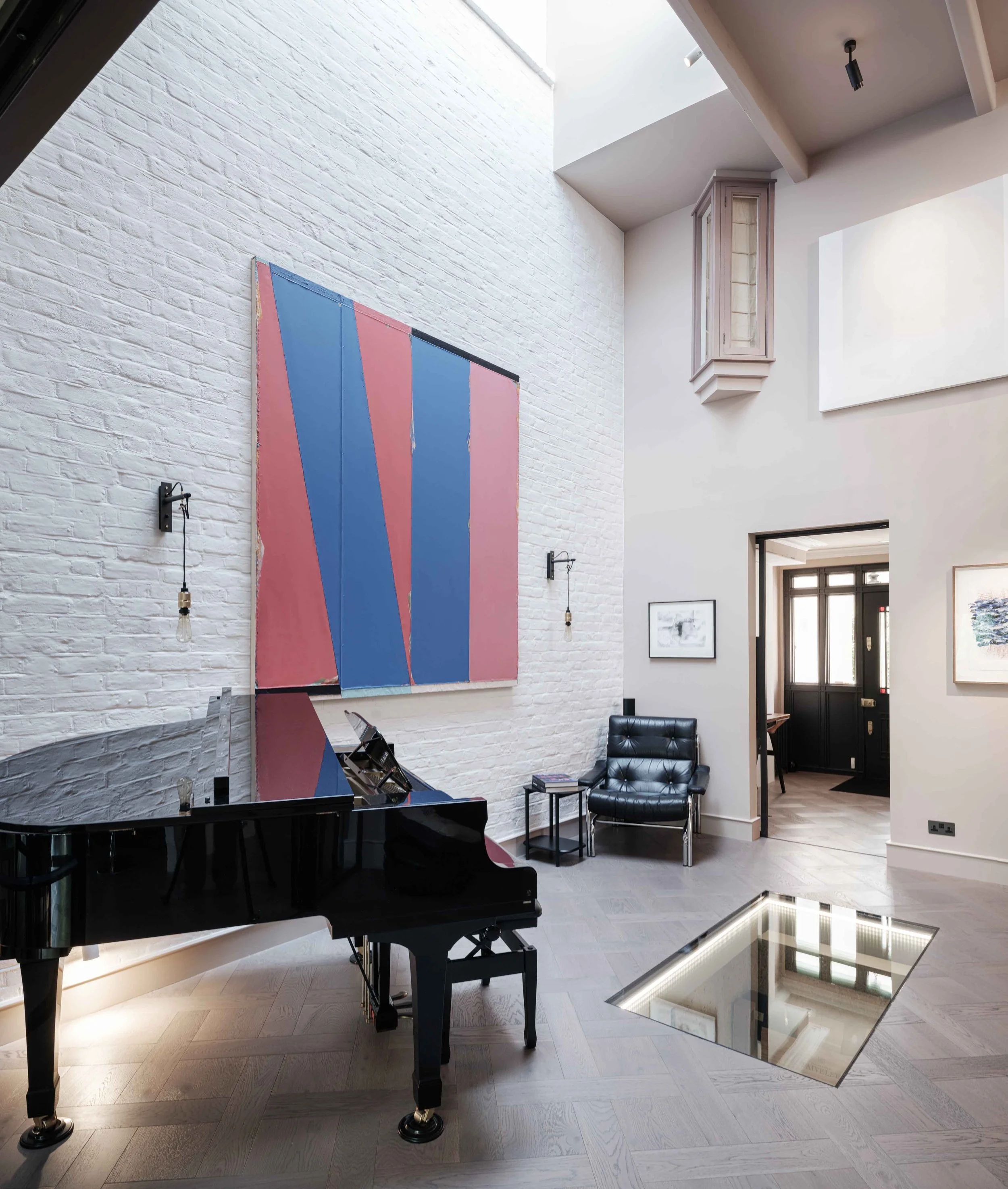 Double height hallway with painted brickwork