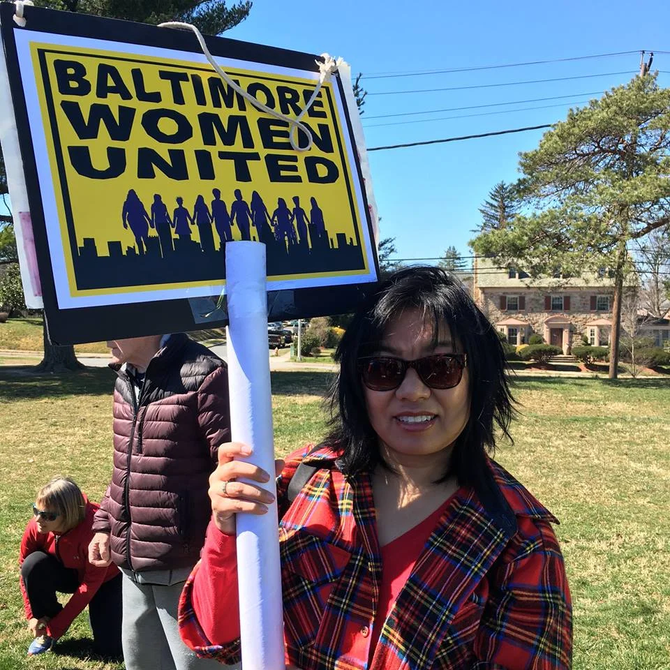 women wiht bwu sign.jpg
