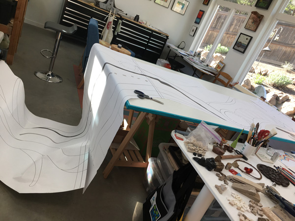 Full size paper cartoon on the work table.