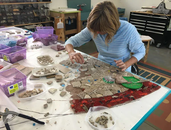Rochelle setting the bottom left of the entry wall piece.