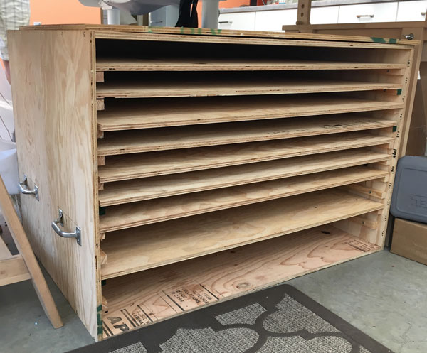 The first crate Rochelle constructed to transport the panels. The shelves come out to load and unload. A door will be attached, to seal for transport.