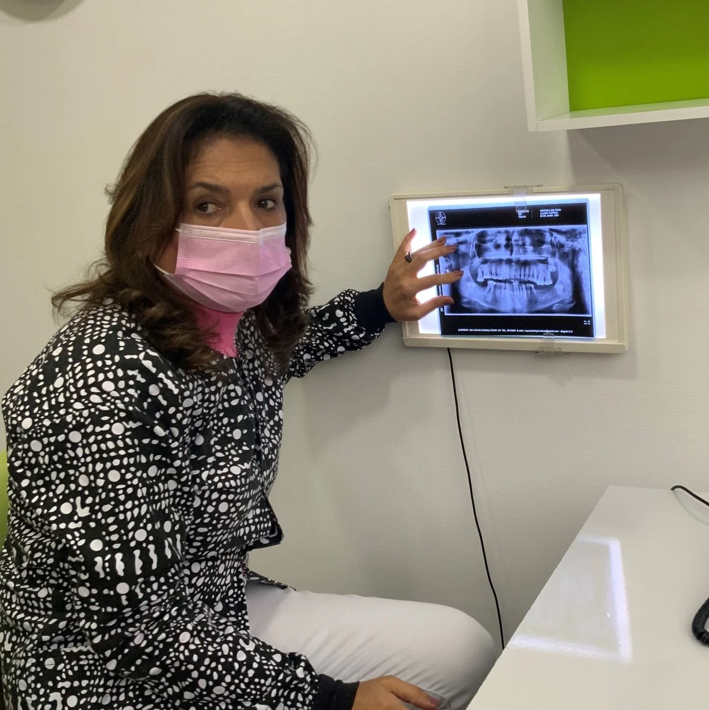 Dentist reviewing jawbone imaging to plan dental implant treatment in Colombia