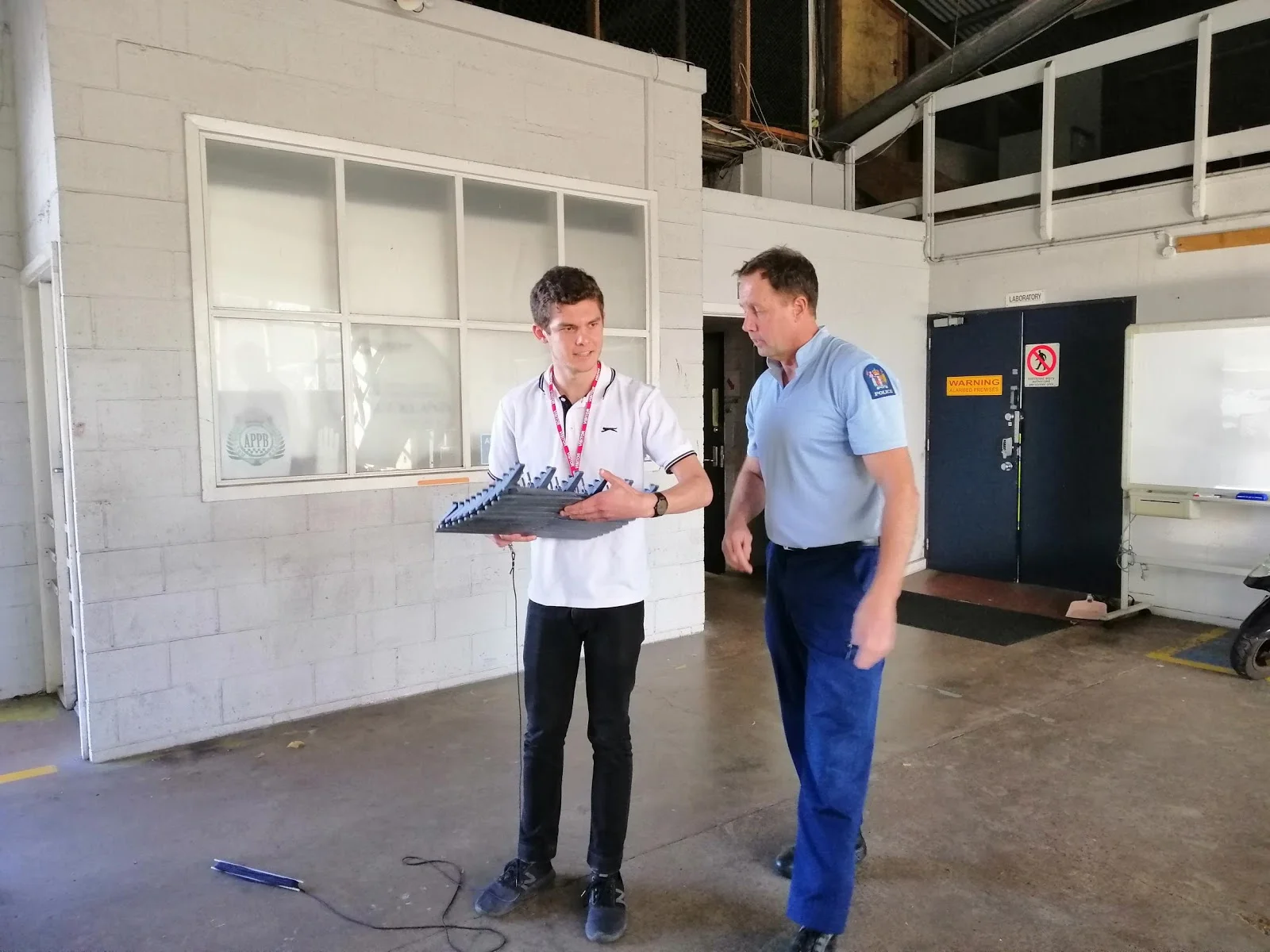 Snr Sergeant Rod Salt gives Dathan Barkhausen the run-down on laying road spikes at Auckland’s Harbour Bridge Police Station.