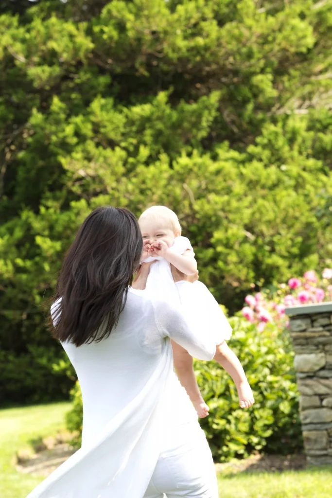 A mother playing with her daughter during family photo shoot