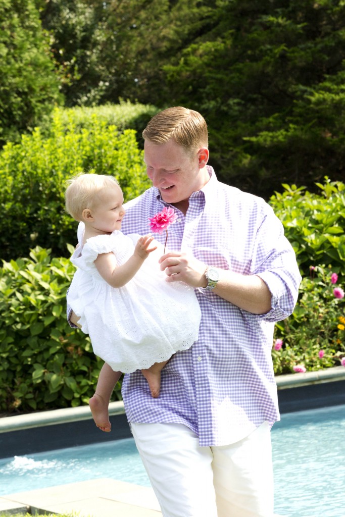  Father picking a flower for his daughter at the photo shoot 