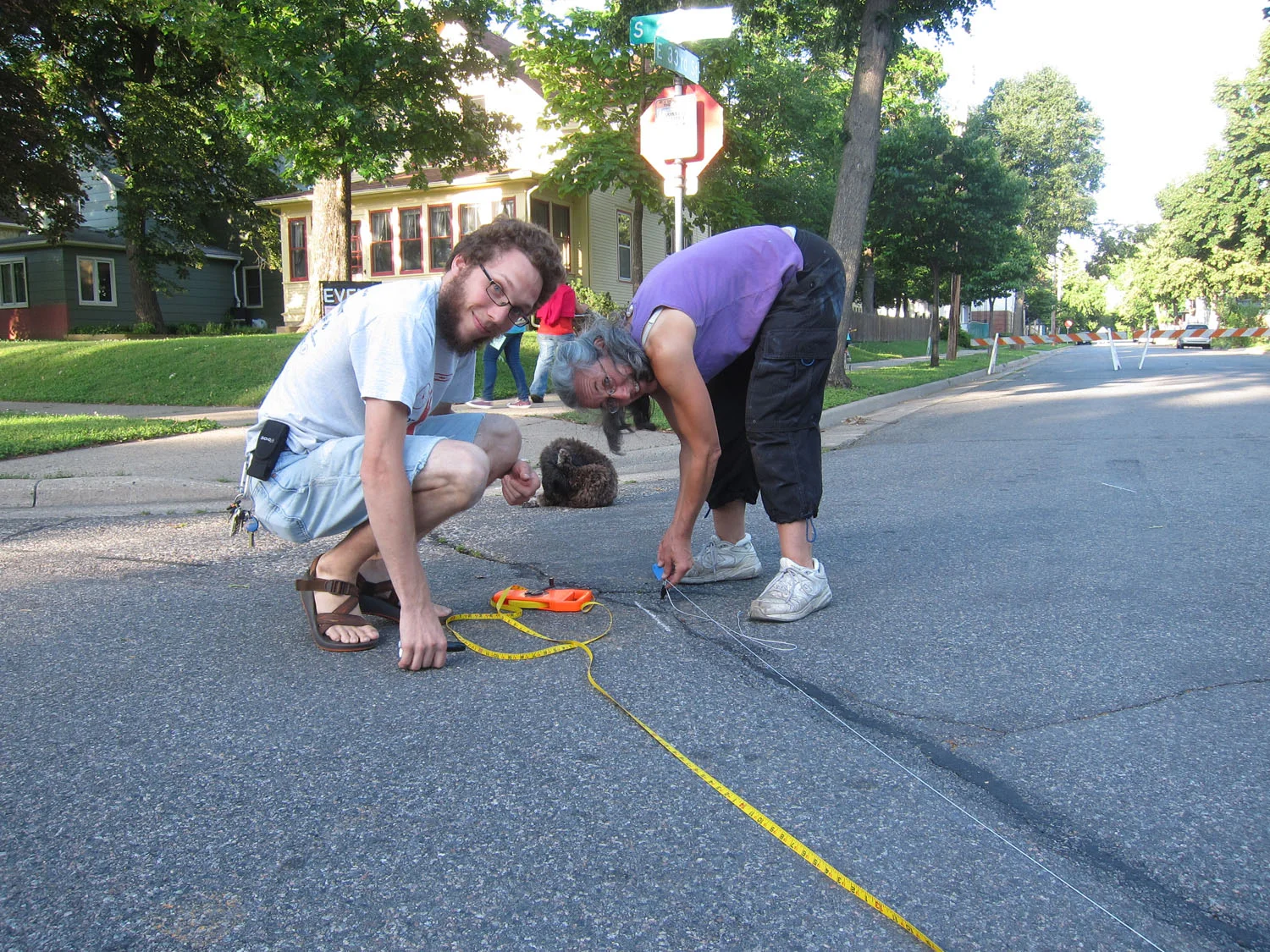 With the help of a mathematician neighbor, we begin to layout the mural on the street.
