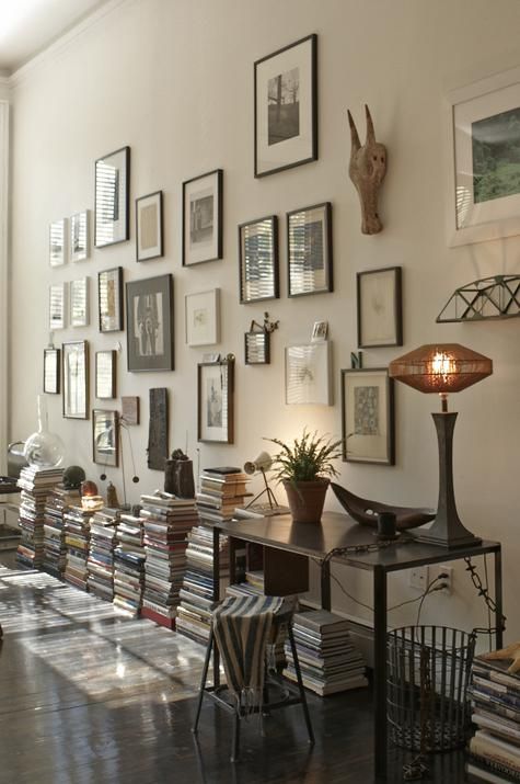 Books under a gallery wall