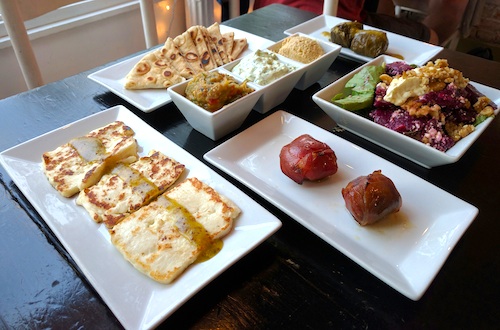 Variety of Greek food in white dishes