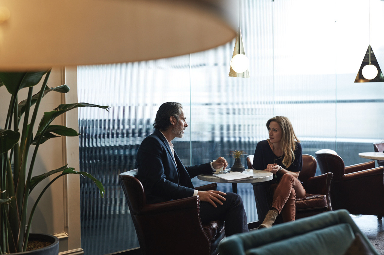 Two people talking in a collaborative workspace