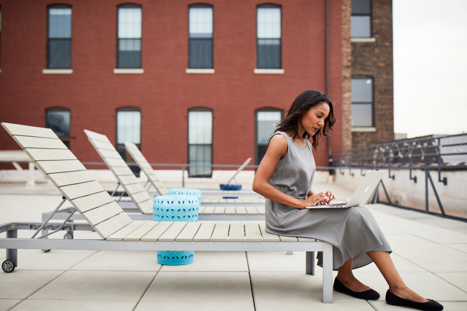 Woman working in an outdoor rooftop office environment