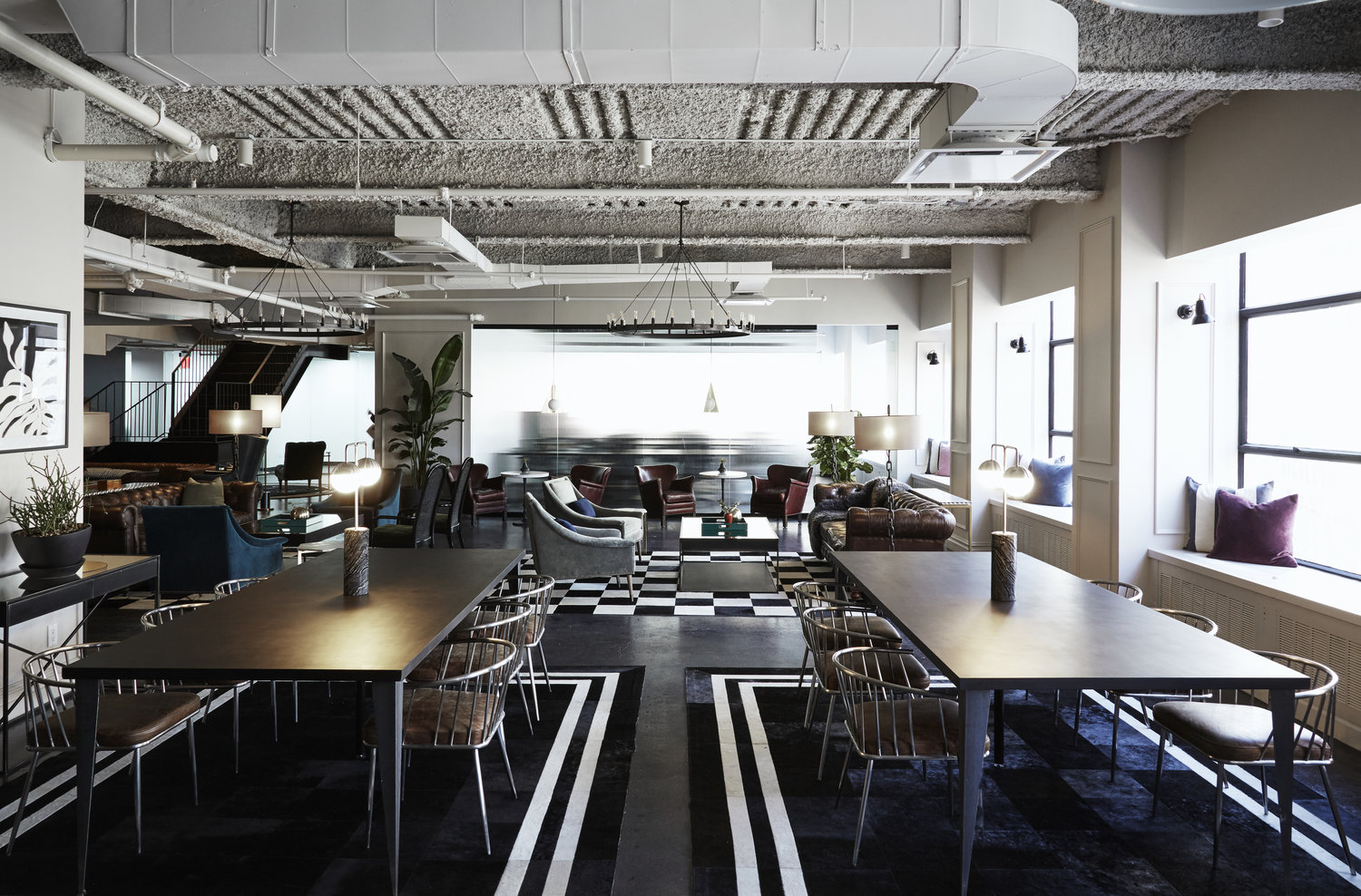 black and white office space with large tables and chairs