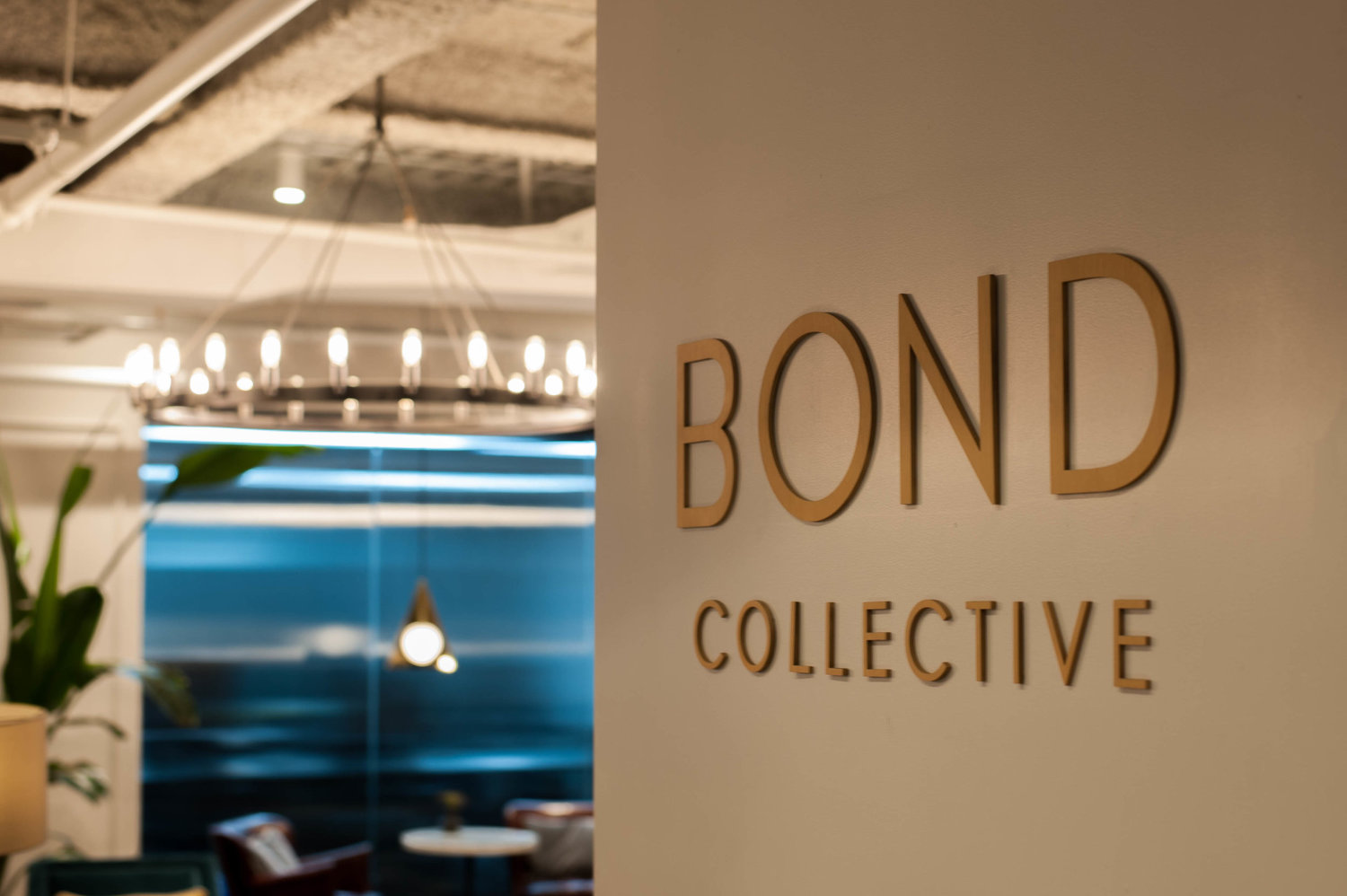 open area at shared office space with Bond Collective branding on the wall