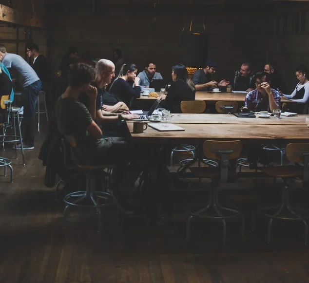 Coworkers sitting around tables having a meeting