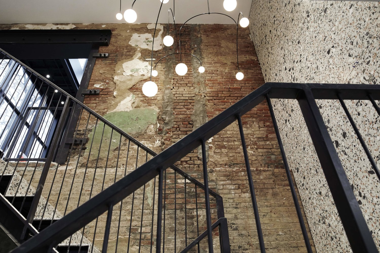 large staircase with stone wall and exposed brick