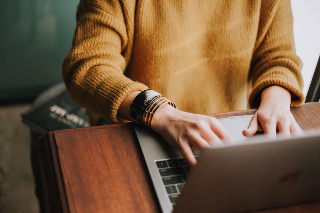 executive preparing to interview prospects by using a laptop to list potential manager interview questions