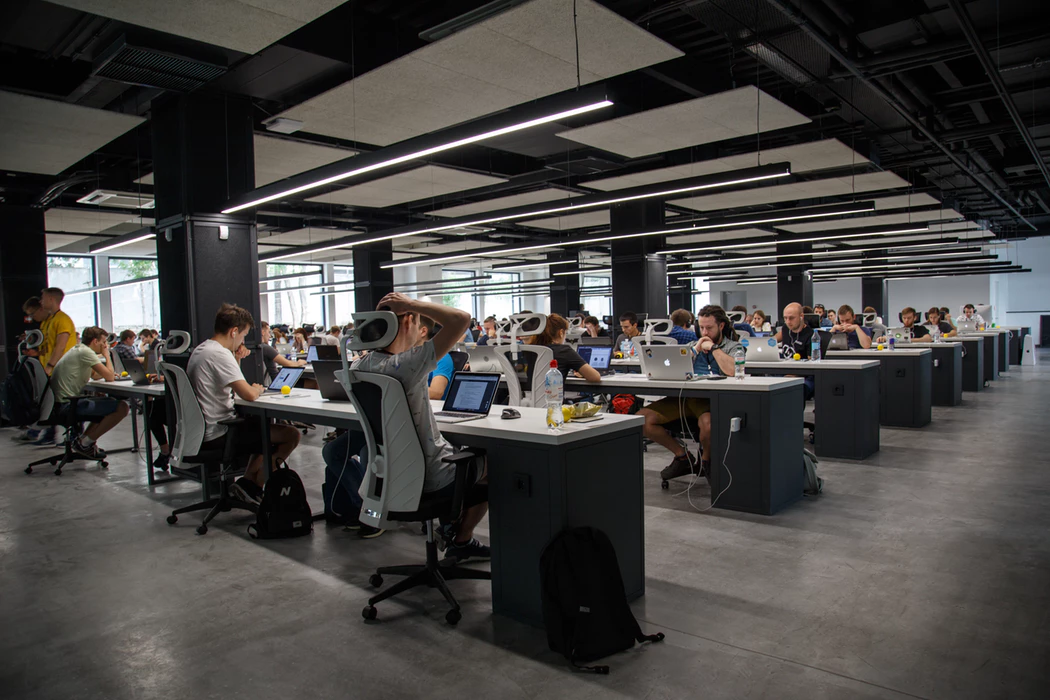 large open office plan area with many desks and team members working