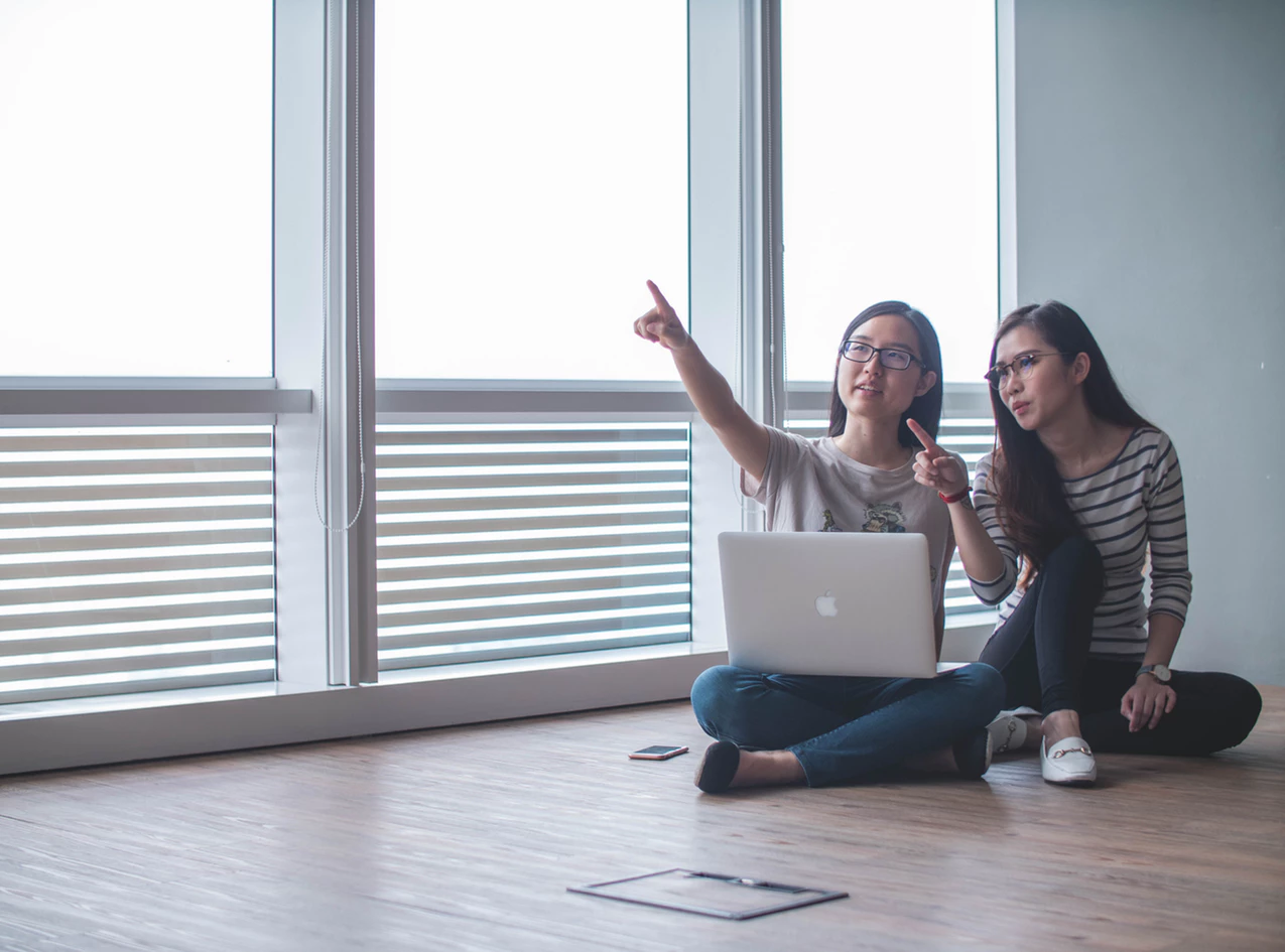 two women in an open space planning an office move