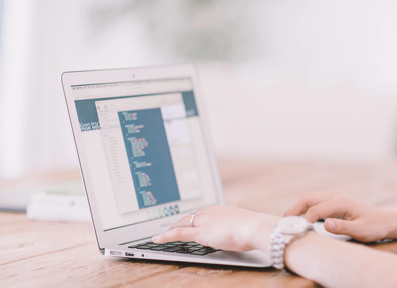 woman using a laptop to conduct remote work