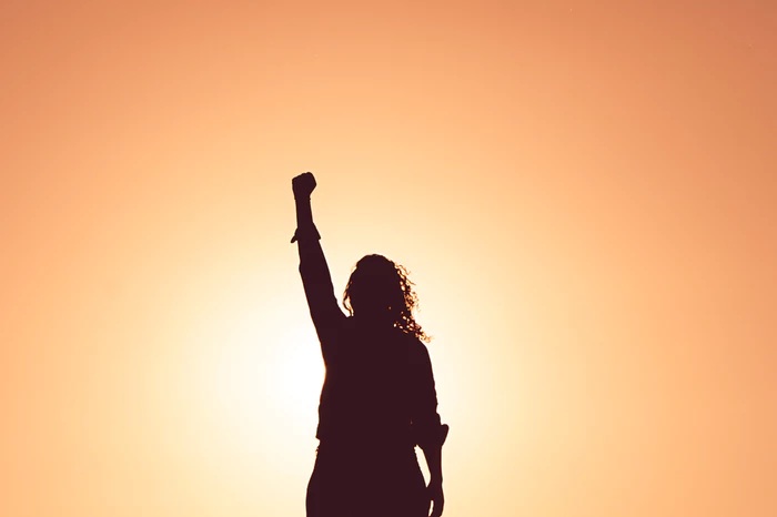 empowered team member with raised fist