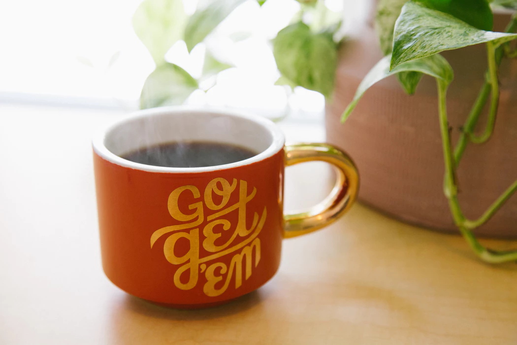 coffee in motivational mug for maximum work productivity