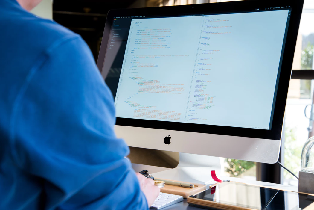 man using desktop computer to remotely manage his business