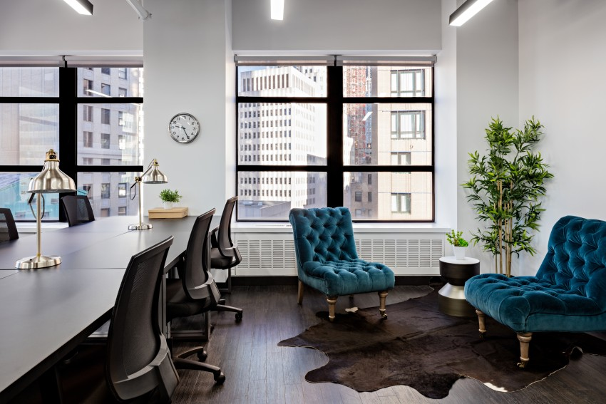 Coworking space with table and chairs as well as two accent chairs