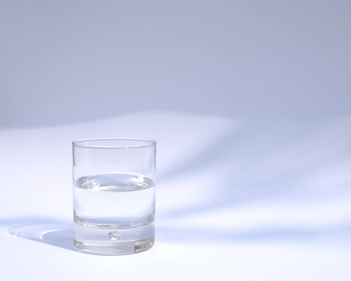 glass of water on a white desk