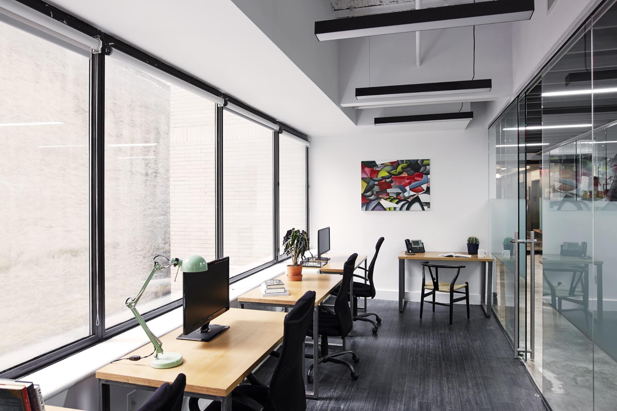 Desks facing windows in a shared work space