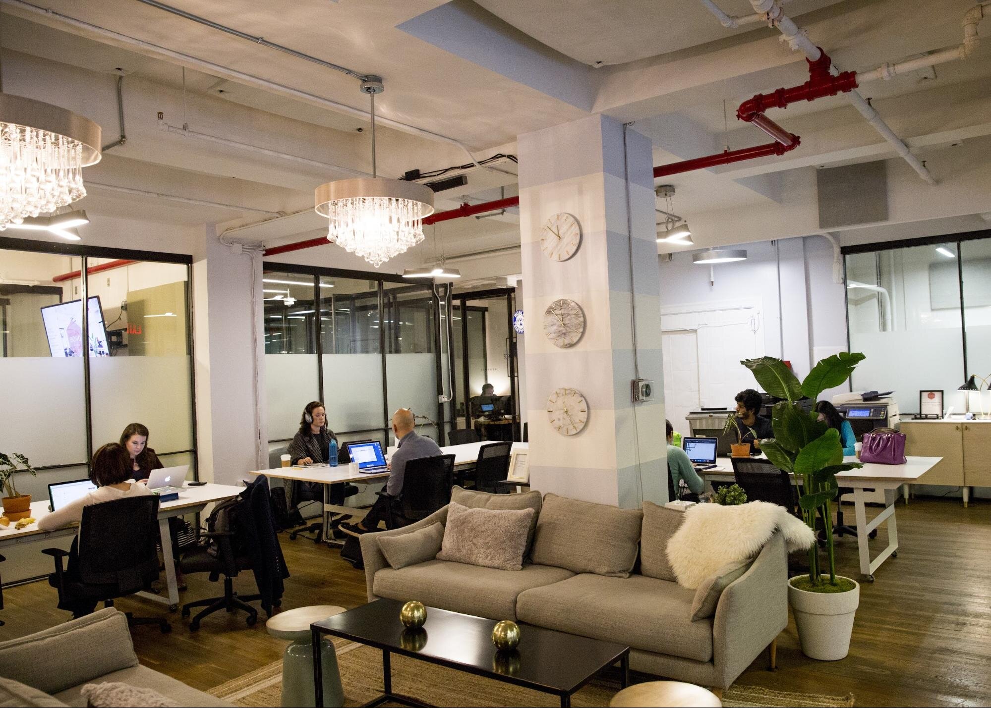 Shared desks, sofas, and tables in a gorgeous office