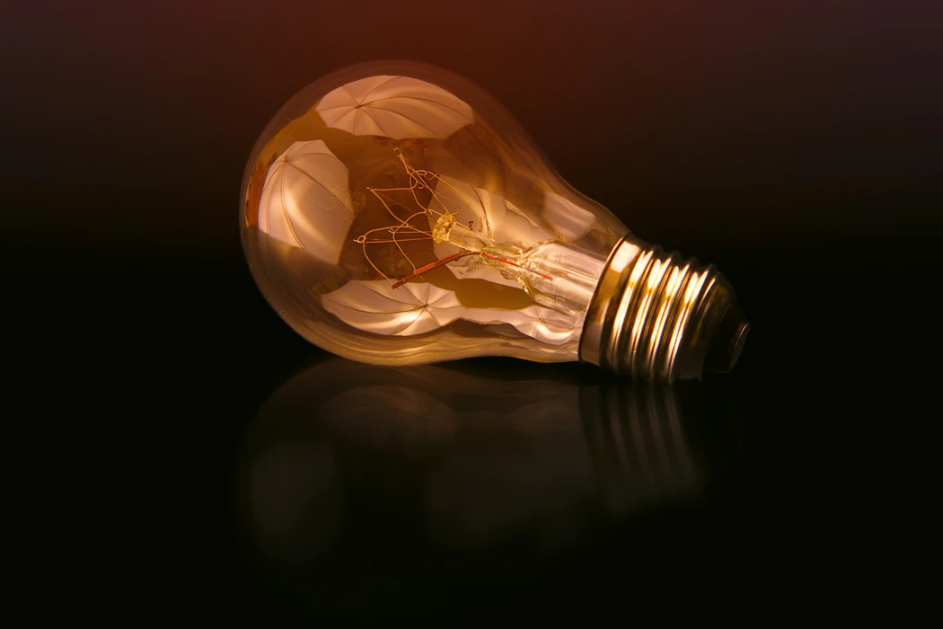 Light bulb on a black surface