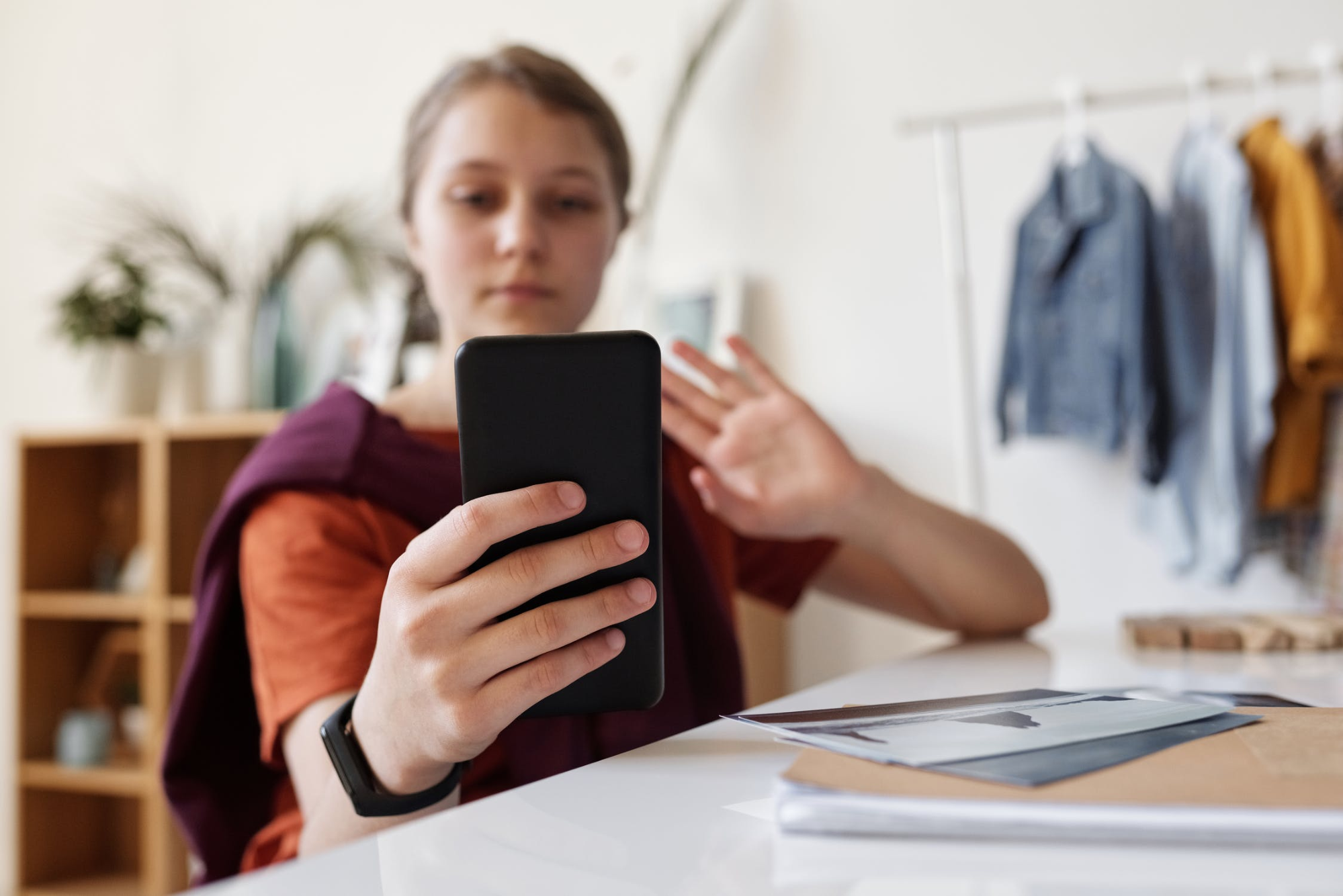 employee using her phone for a virtual meeting