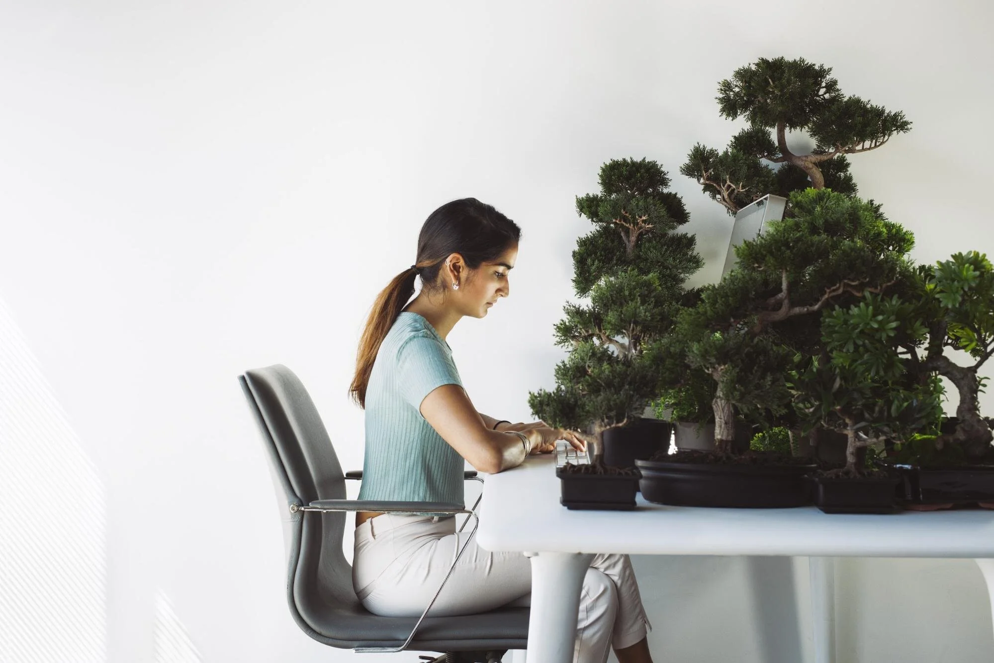 woman working in home office with plants