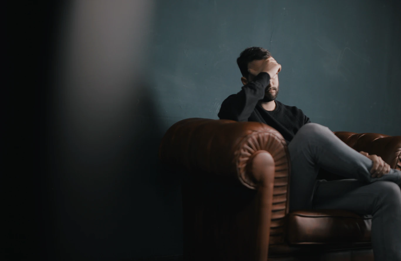 Man with a headache because of employee burnout