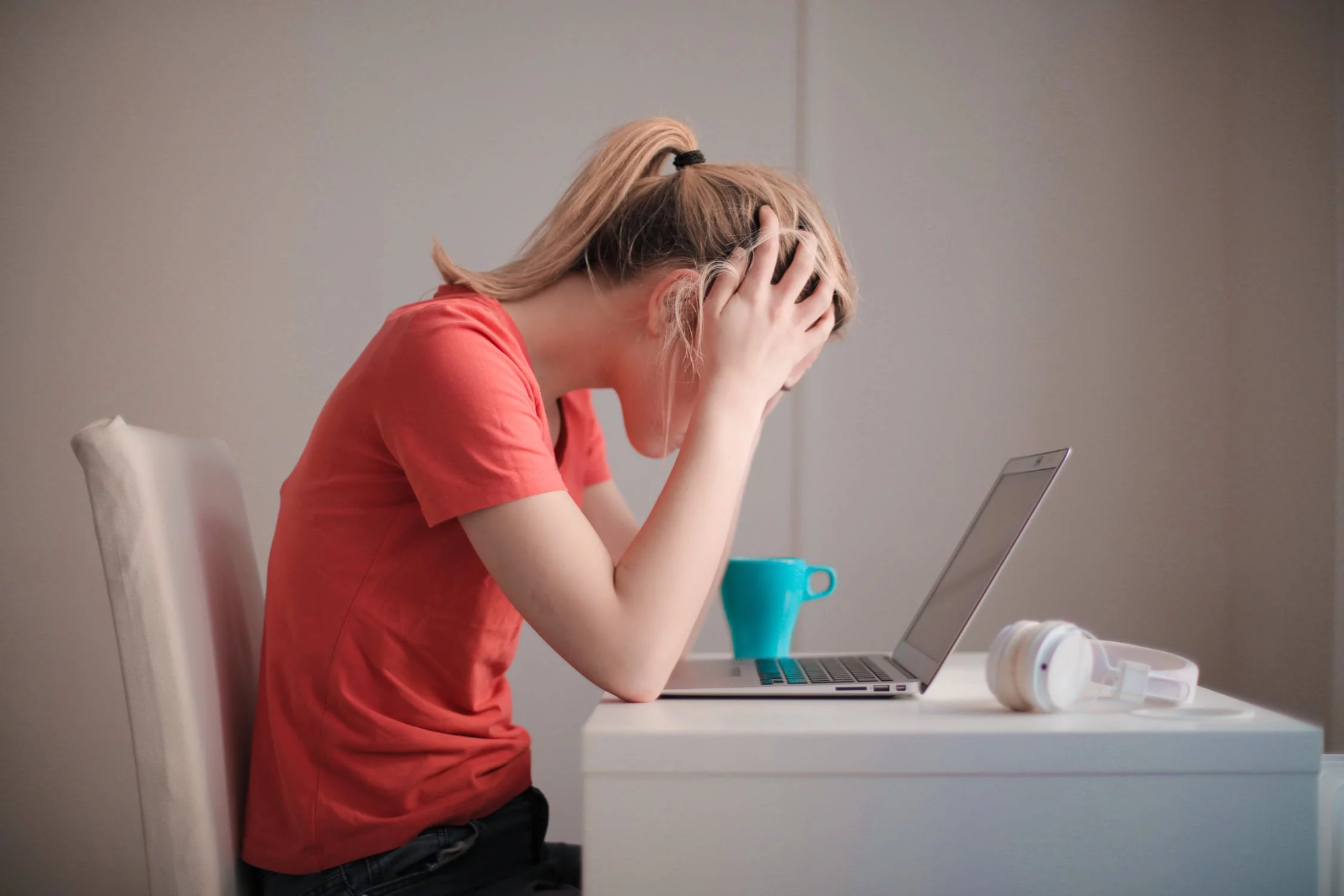 Woman with hands on her head experiencing employee burnout