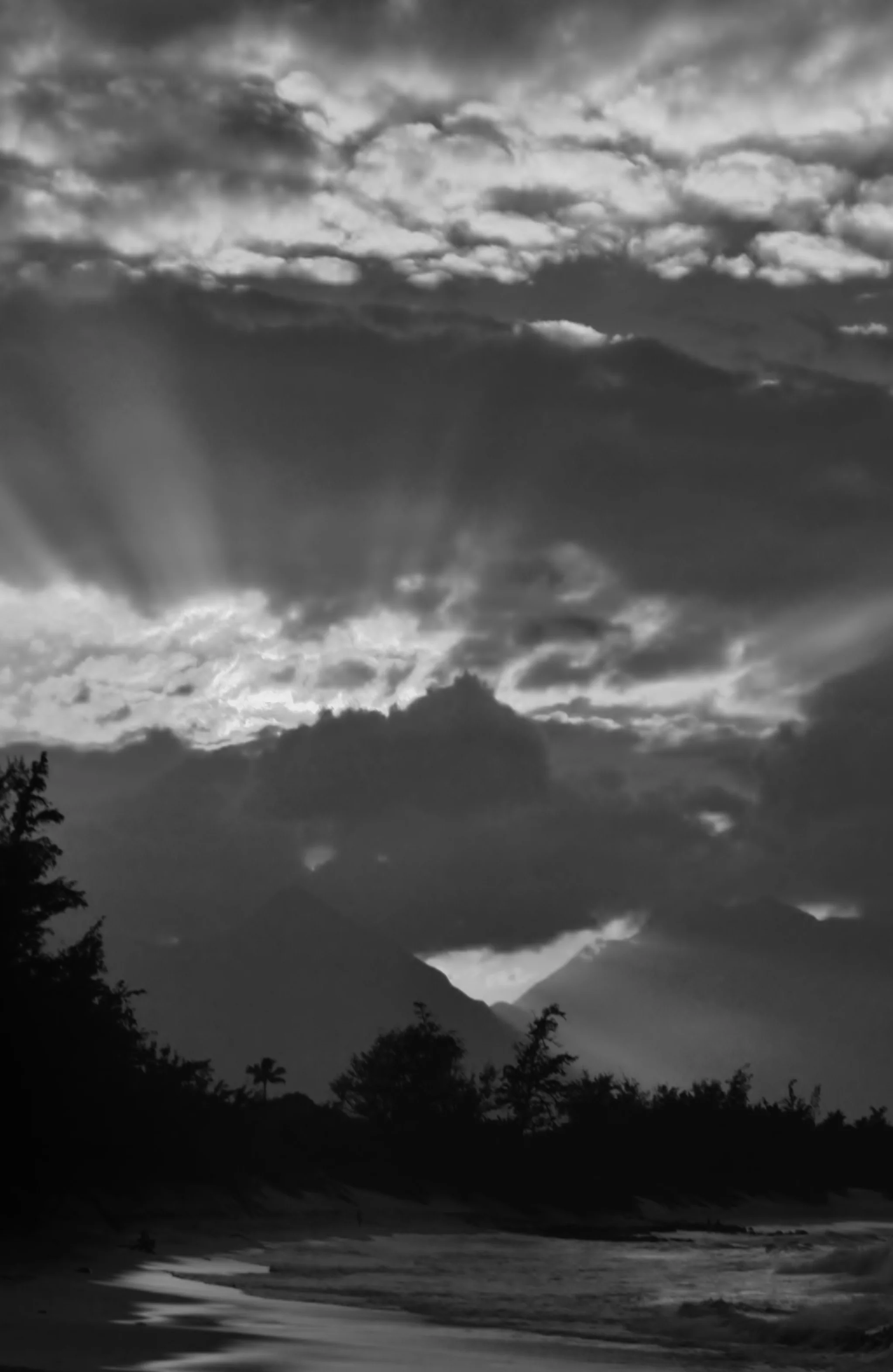 photo black and white beach mountains sun rays.jpg