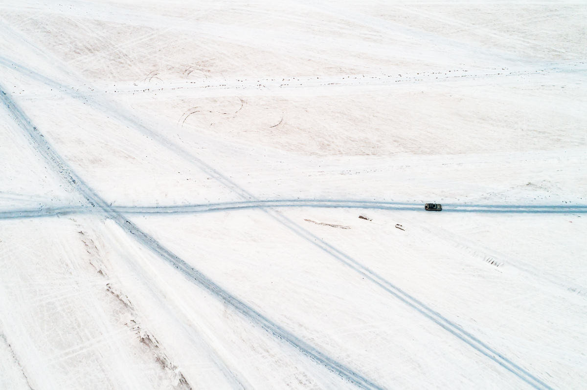 blue-white-salar-de-uyuni-salt-flats-potosi-bolivia-car-tracks-vast-expanse-desert-vastness-jeep-4x4-wheel-drive-road-roadtrip-south-america-drone-dji.jpg