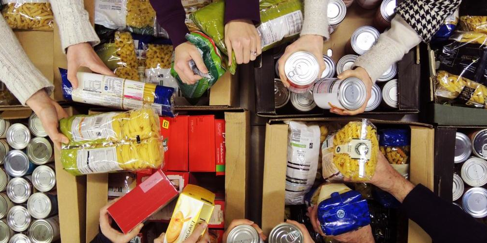 OKLearns volunteers adding food to a Christmas Hamper