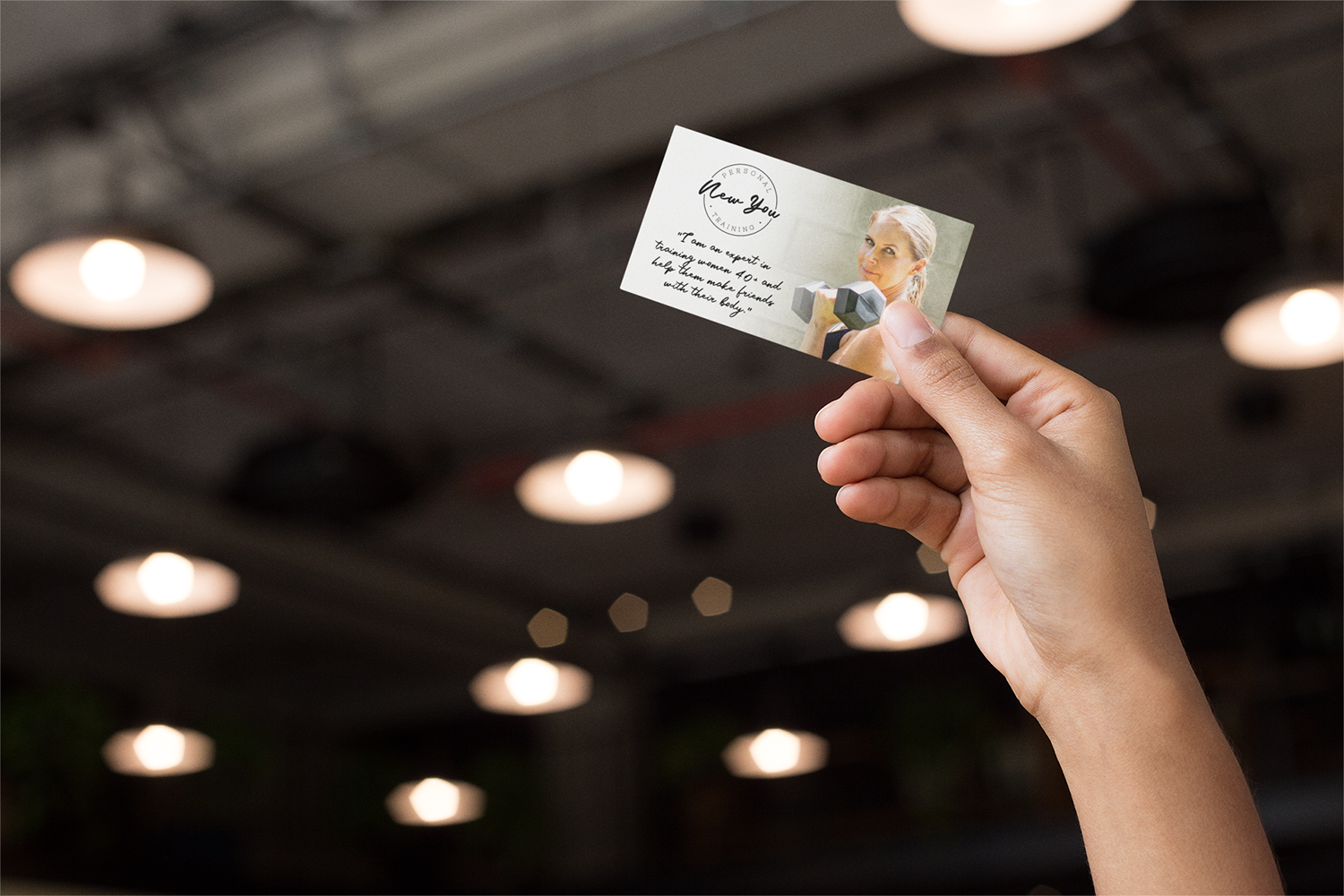 mockup-of-a-business-card-being-held-against-a-roof-21920.png