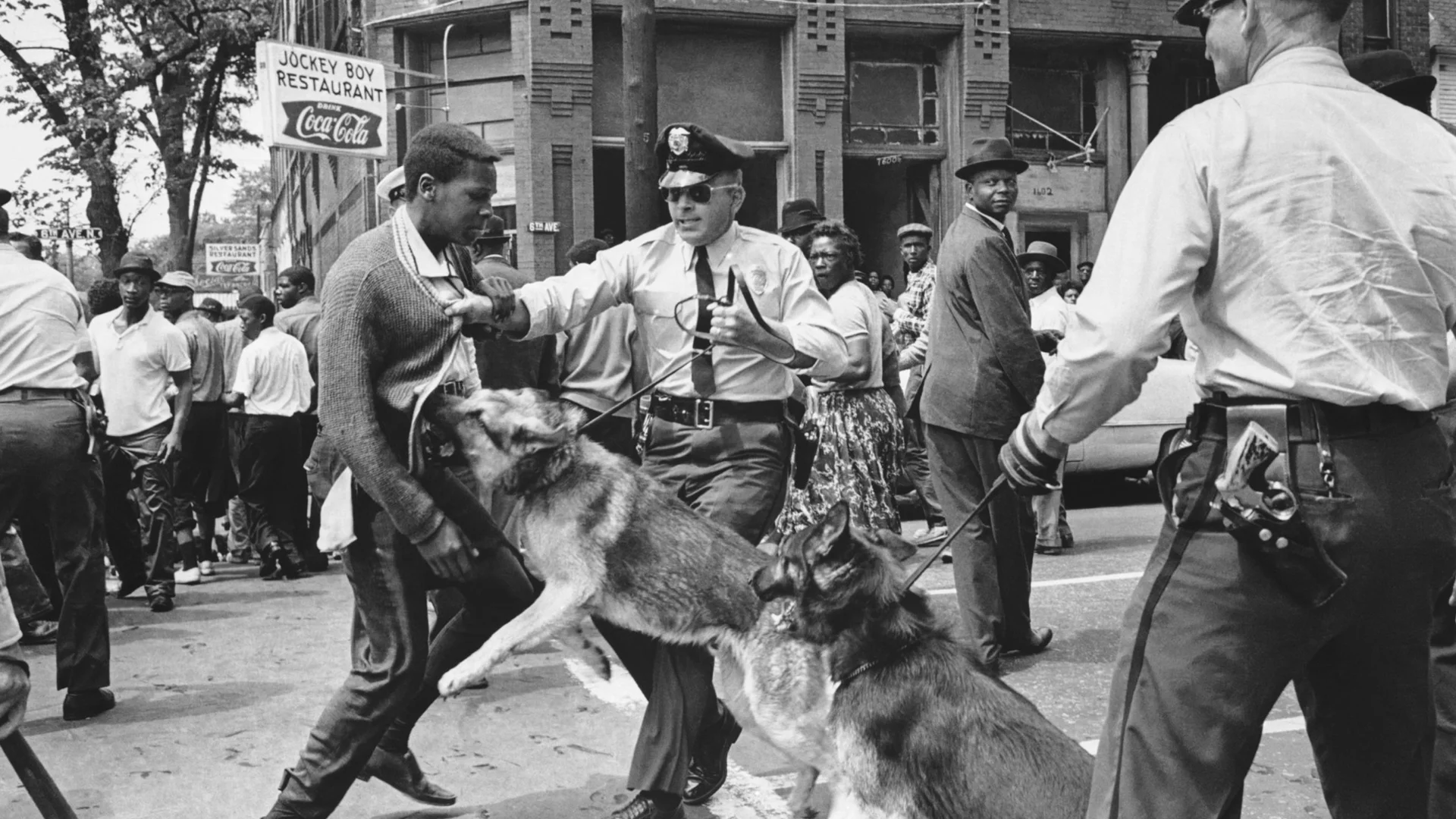 Civil Rights Protest USA. Brimingham, Alabama. 3 May, 1963. A 17 year old African American civil rights activist is attacked by police dogs during a demonstration. The photo was published in The New York Times the following day, helping shift support to the protesters with President Kennedy calling the scenes "shameful". (AP Photo/Bill Hudson)