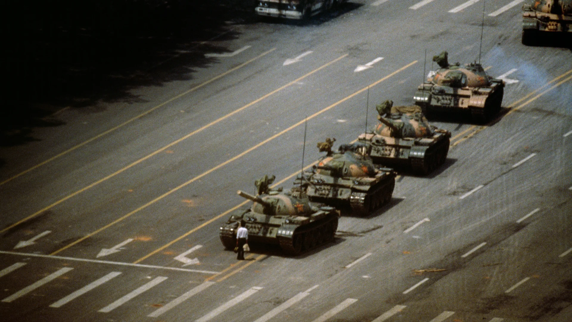 The Unknown Protester China. Beijing. Tien An Men Square. 4 June 1989. 'The Tank Man' stopping a column of T59 tanks the morning after the Chinese military had suppressed Tiananmen Square protests by force, killing at least several hundred demonstrators. The identity and fate of the 'Tank Man' is still unknown. (Photo: © Stuart Franklin/Magnum Photos)