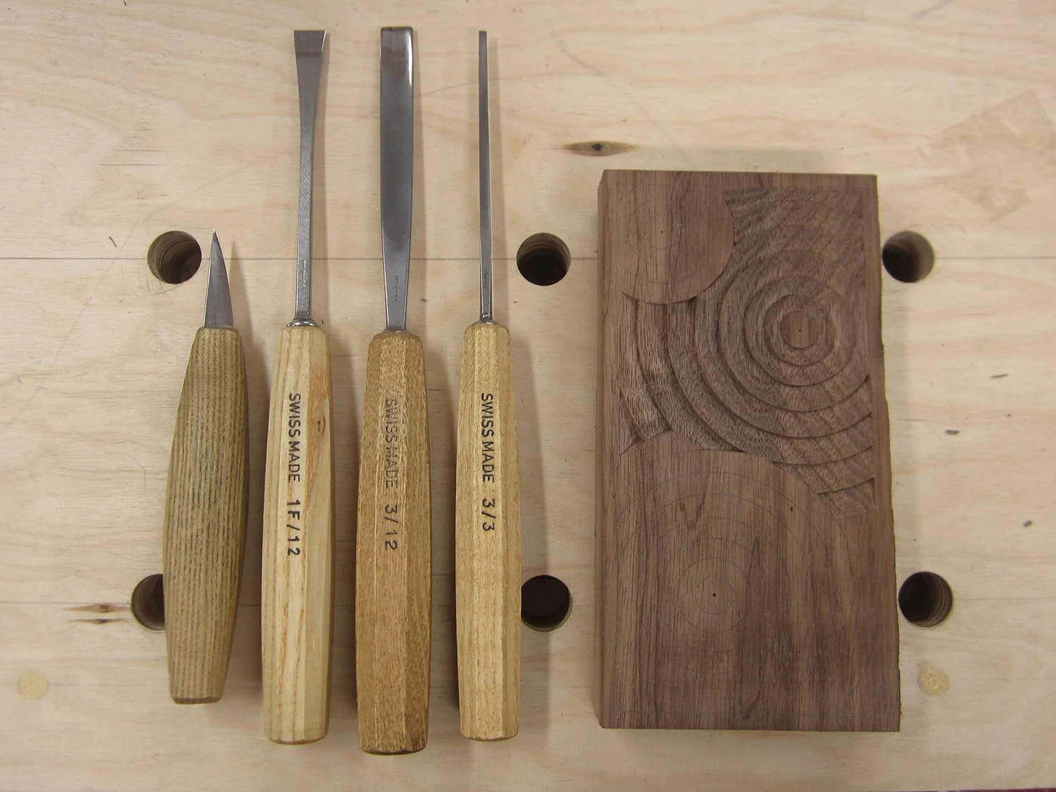 These are the tools I've been using for my most recent concentric circles carvings. EDIT: It's actually been a couple weeks since I took this pic, and I've since refined my method. I don't use the first straight chisel, just the knife and the two #3 gouges.