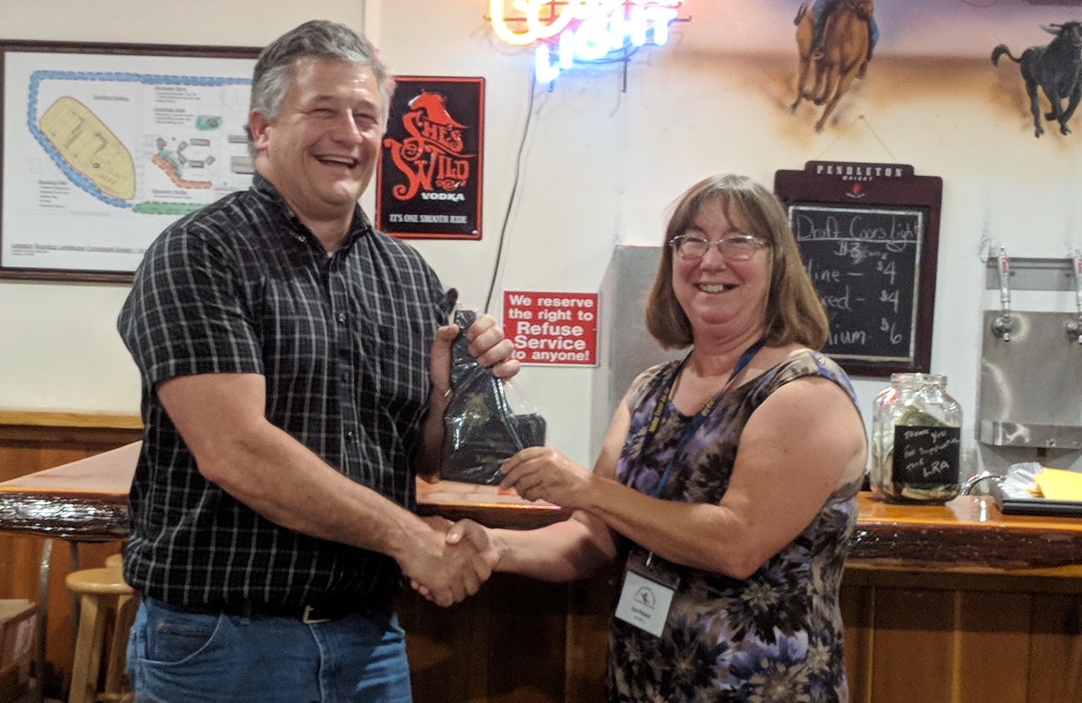 Ray Shirts, Vallivue FFA Advisor, accepts the award for the 'Outstanding Agricultural Program' from Past IATA President and Past Homedale FFA Advisor, Sue Poland.
