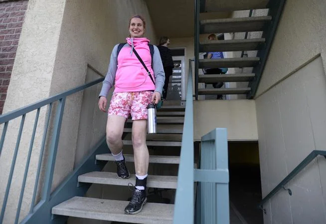 Sophia walks down the stairs, headed to her basketball practice. Sophia is living independently in the community through the Tuneberg Remote Supports Project, which uses technology customized by Simply Home.
