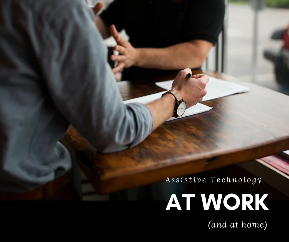 Two men working at a table with the caption "Assistive Technology at work and at home".jpg
