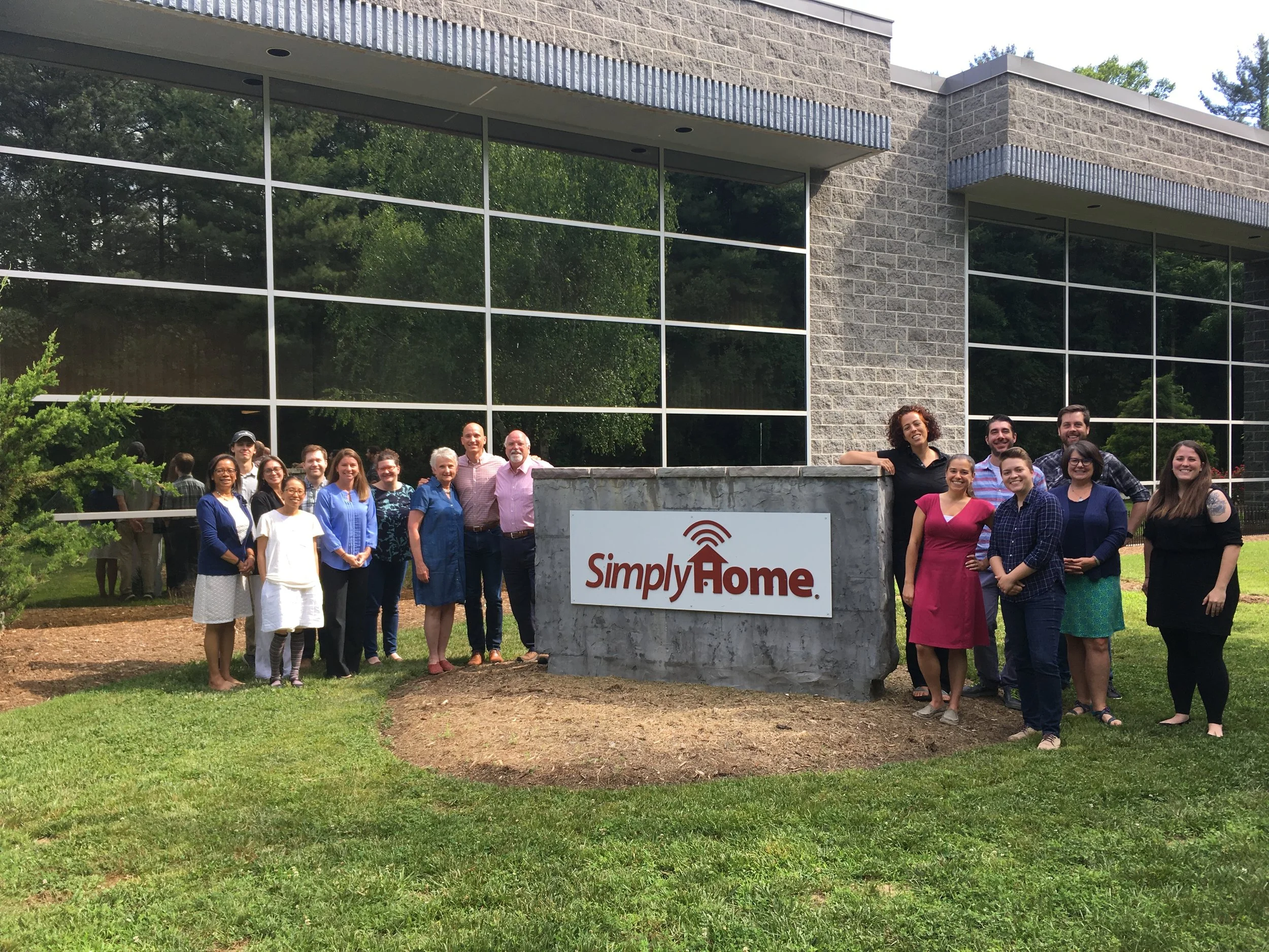   Members of the  Simply Home team pose for a picture outside the company’s Asheville offices.  