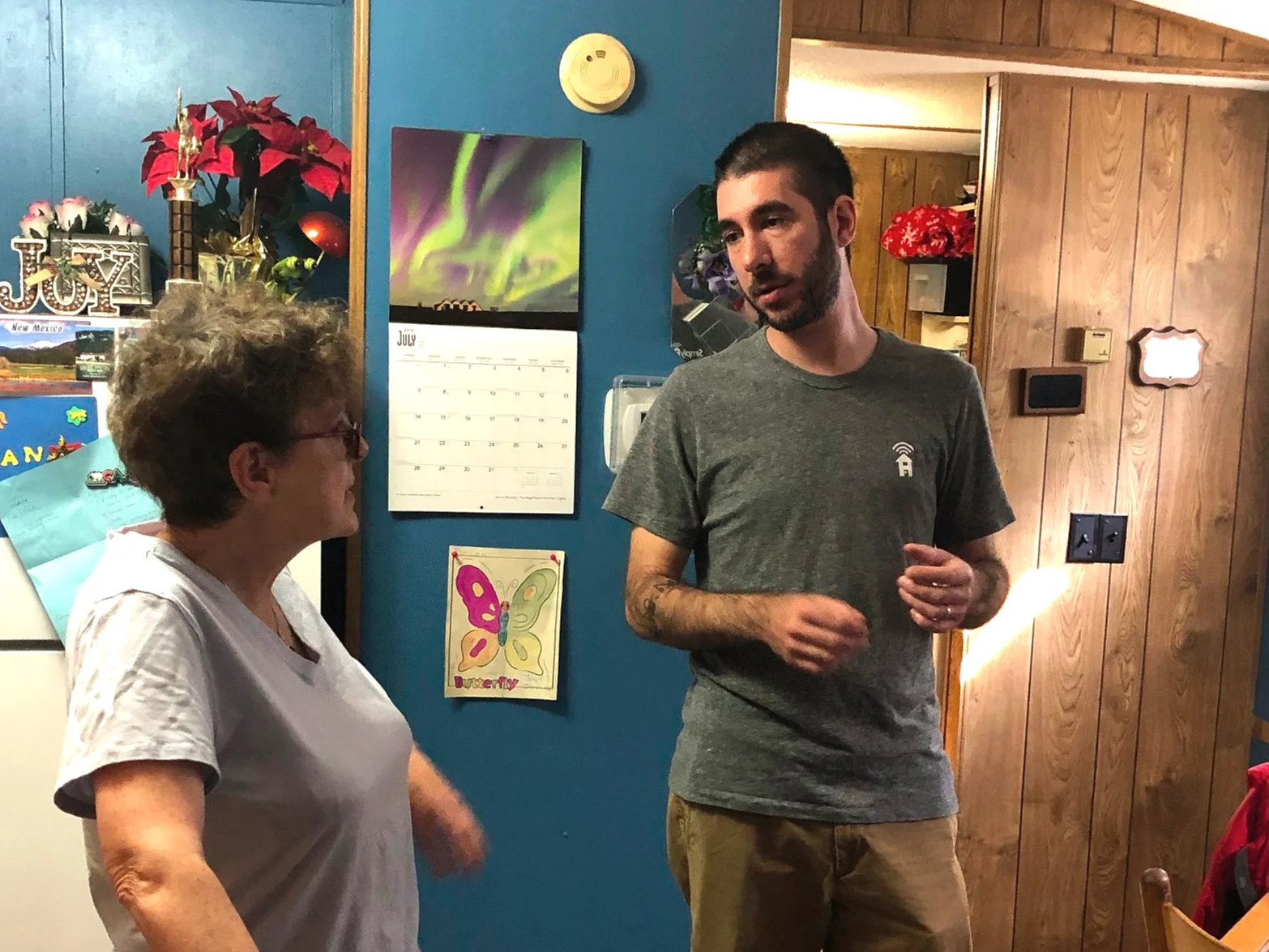 A Simply Home technician discusses the installation process with a client’s family member.