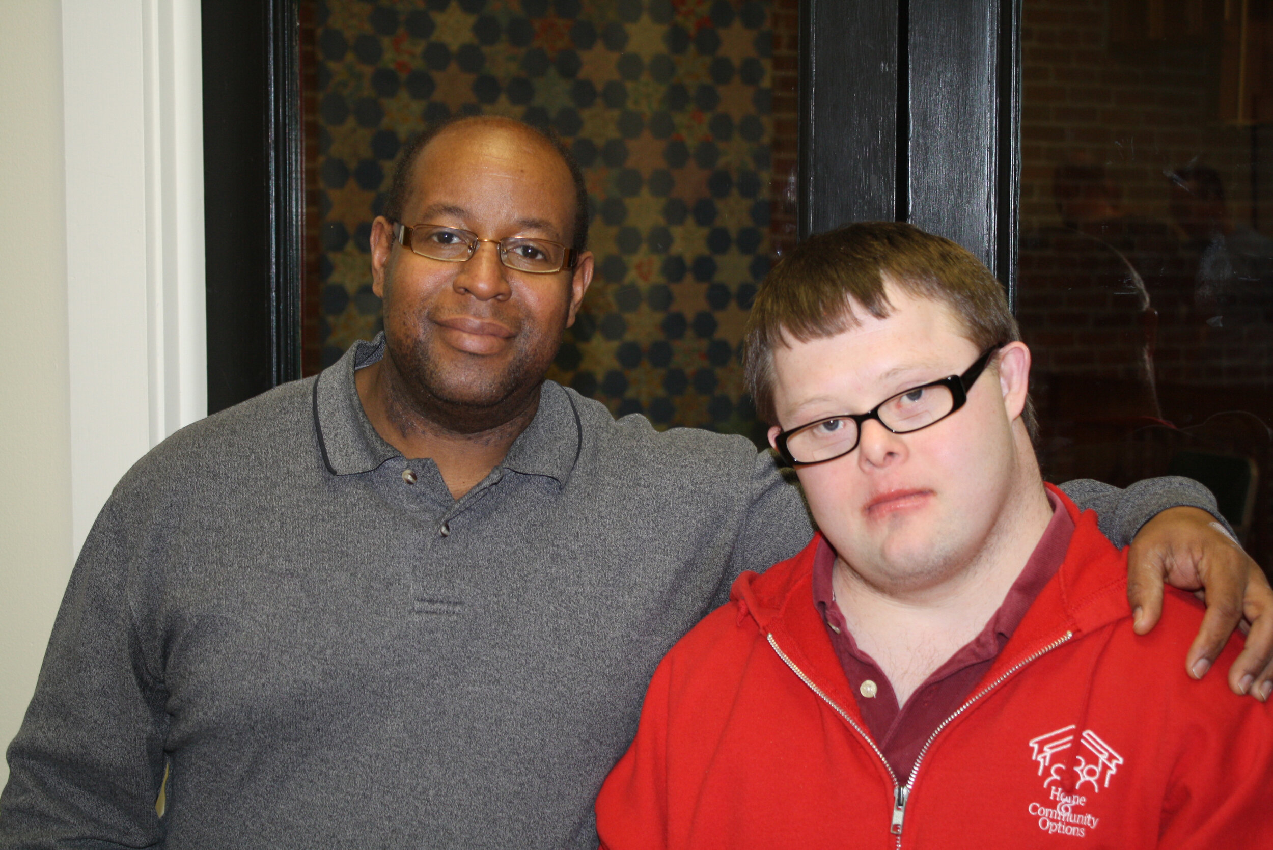   Marcus (left) poses with Eric, one of the individuals he works with. Marcus is known for being an exceptional DSP and a tireless advocate at    Home & Community Options, Inc.   , where he works.  